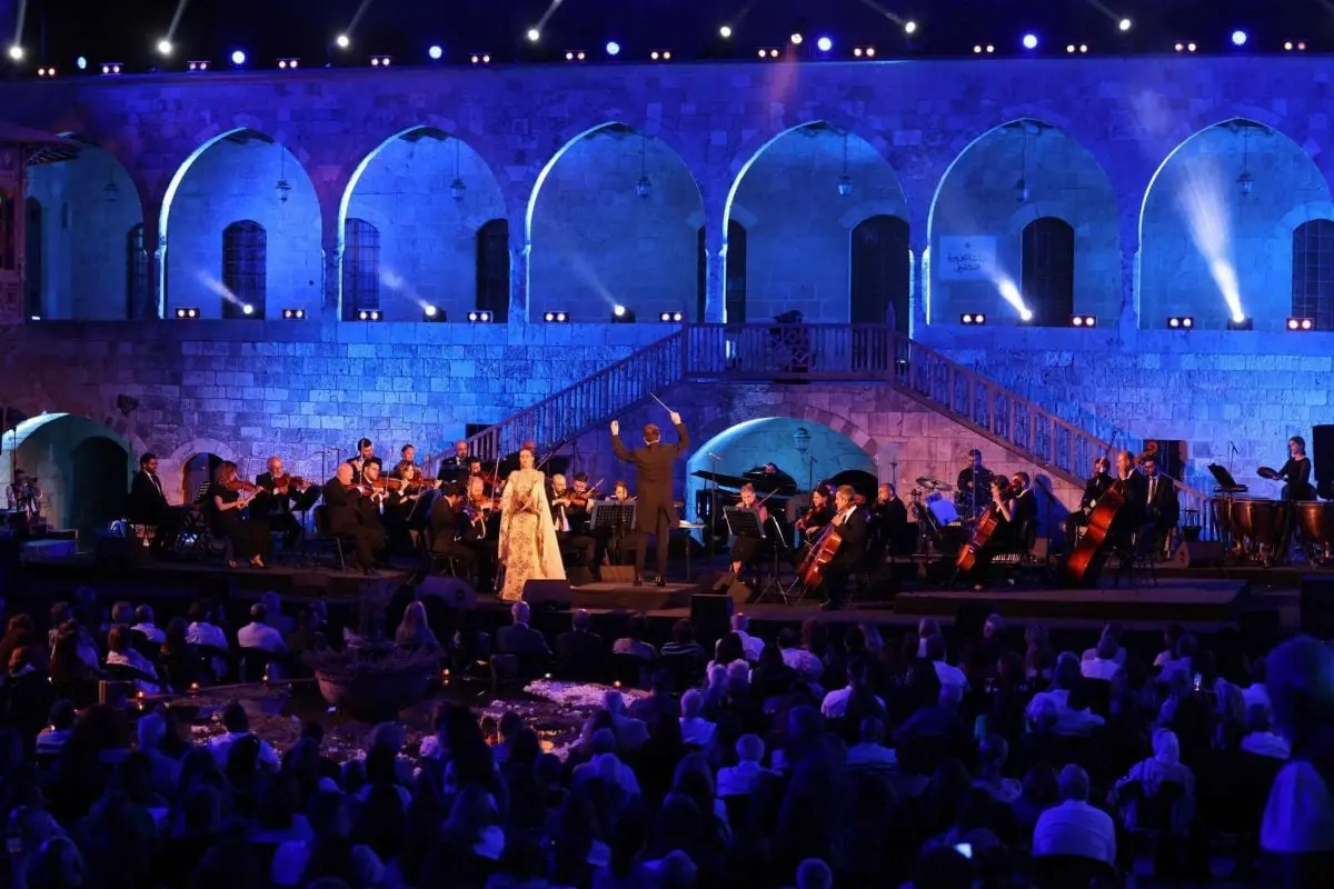 Beiteddine Art Festival concert in the palace courtyard with illuminated arches during Lebanon festivals.