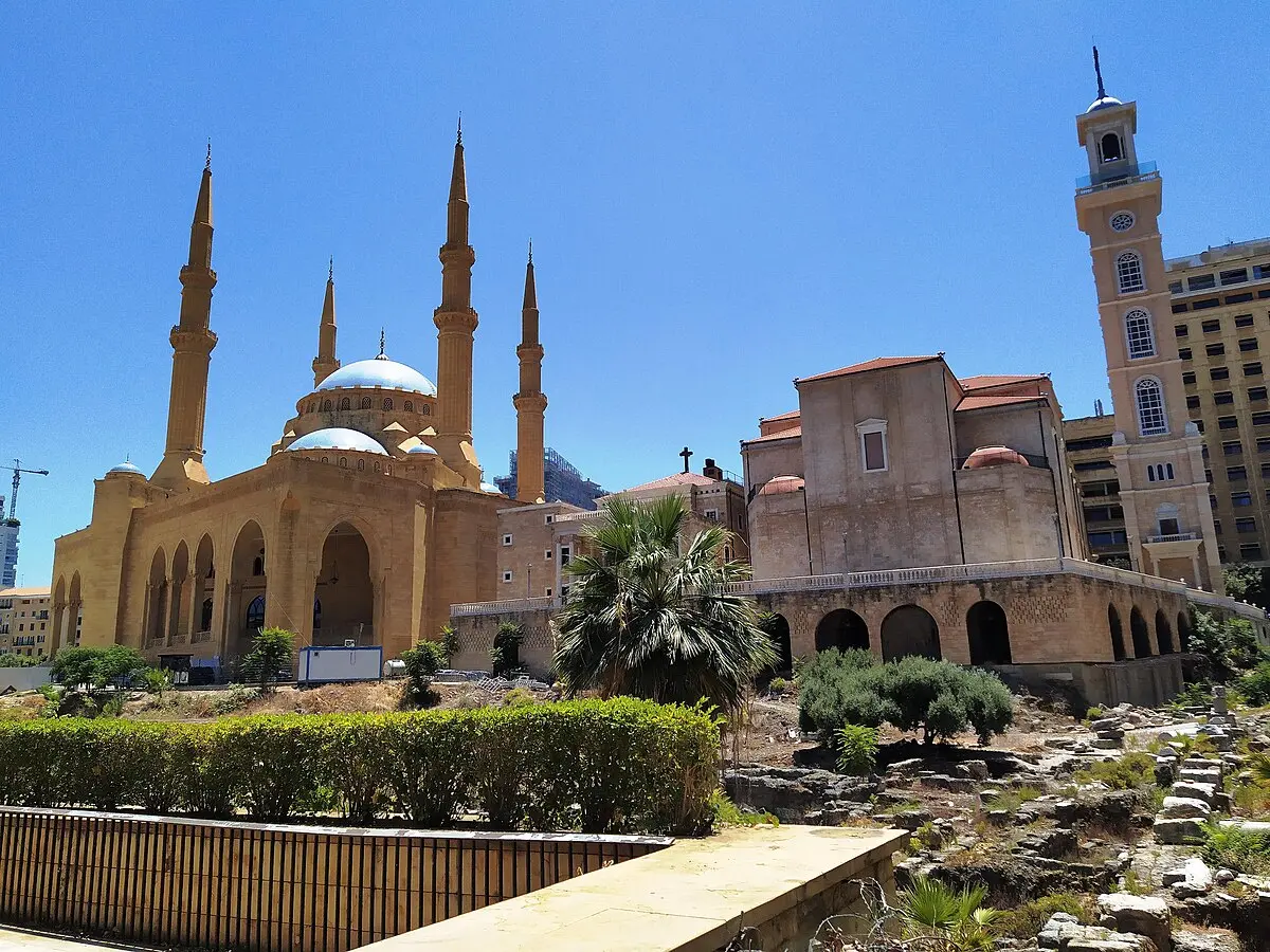 The Mohammad Al-Amin Mosque and Saint George Maronite Cathedral side-by-side in Beirut, symbolizing Lebanon's confessional system.