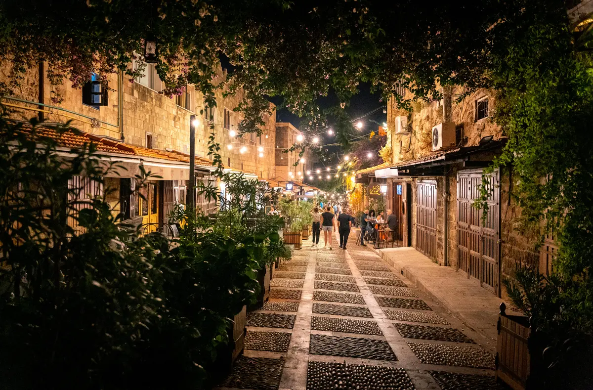 Lebanon Nightlife: The Ultimate Insider's Guide 5 The ancient stone alleyways of the Byblos old souk, illuminated at night with bars and people.